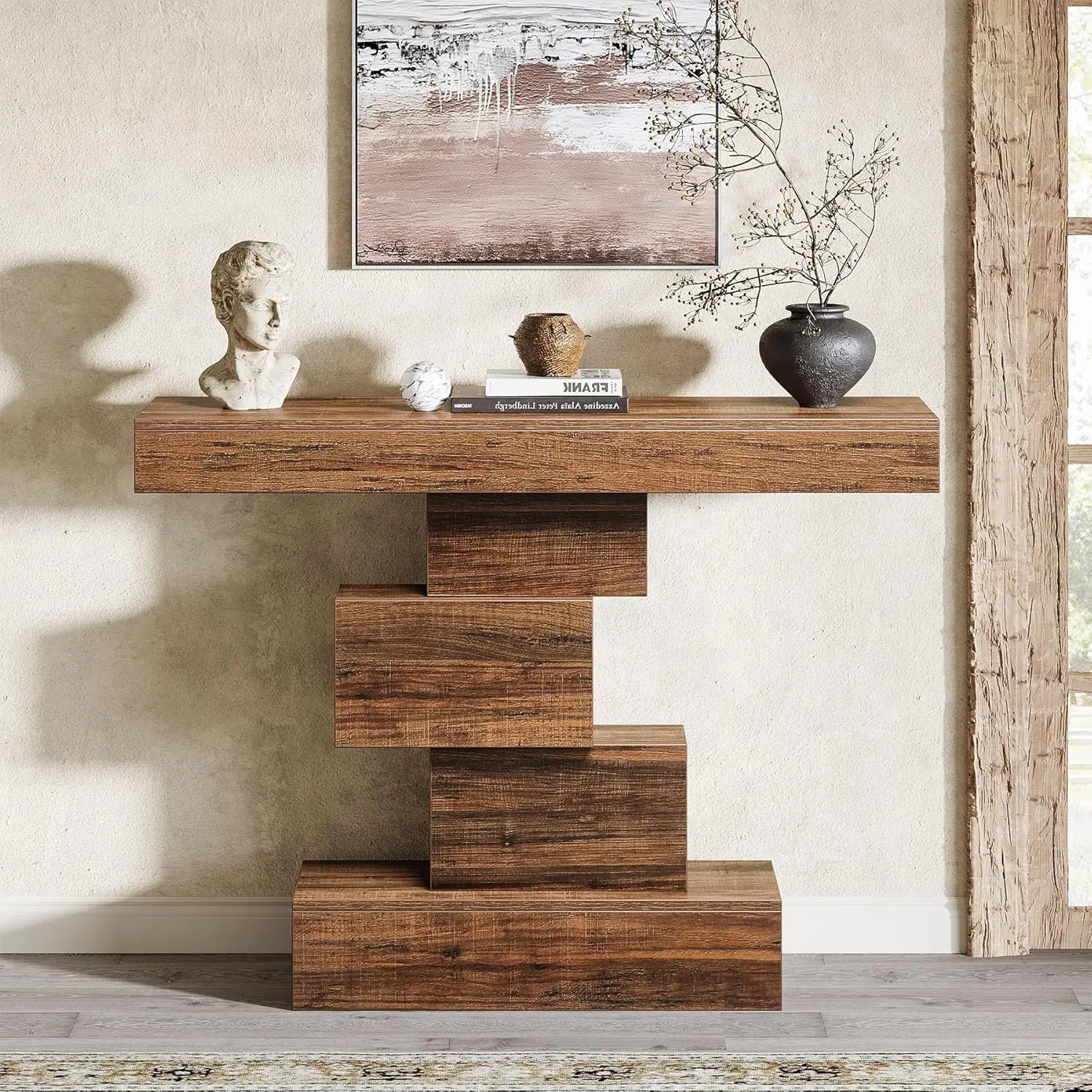 Wooden console table with decorative items against a neutral wall.