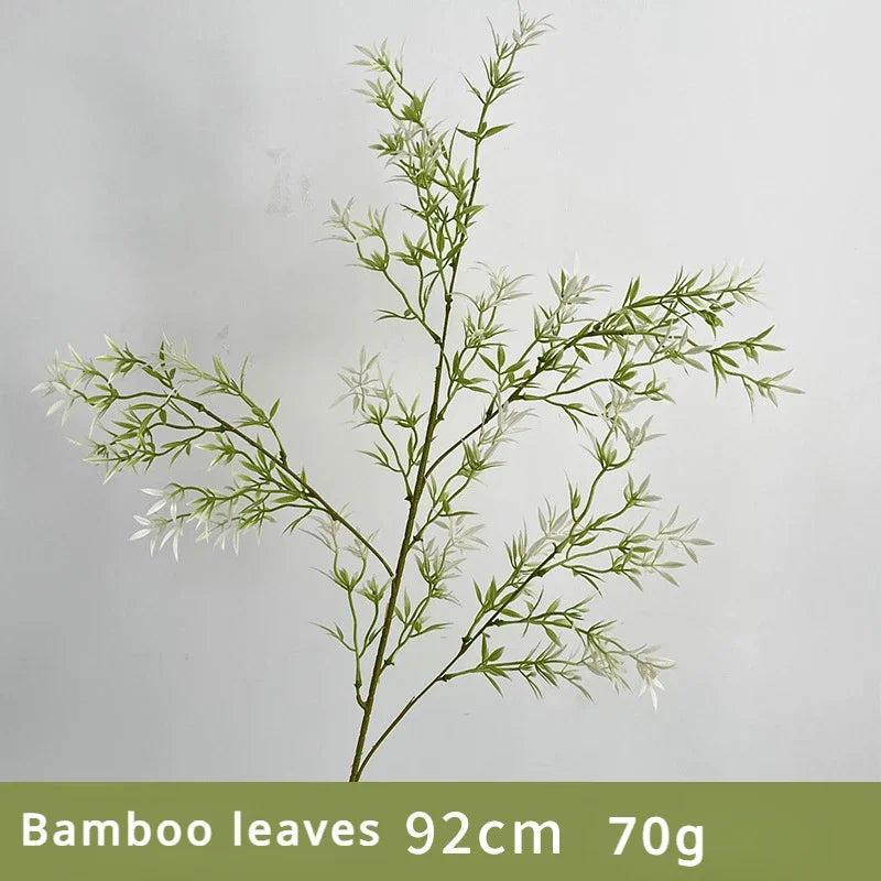 Artificial bamboo branch with green leaves on a gray background