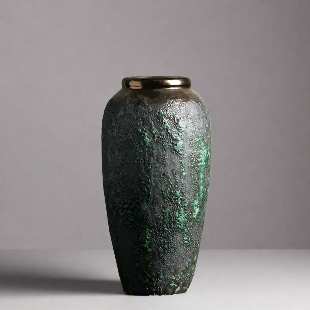 Decorative vase with textured surface on a wooden surface and light gray background
