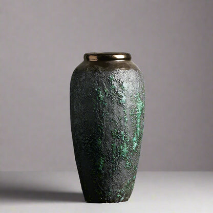 Decorative vase with textured surface on a wooden surface and light gray background