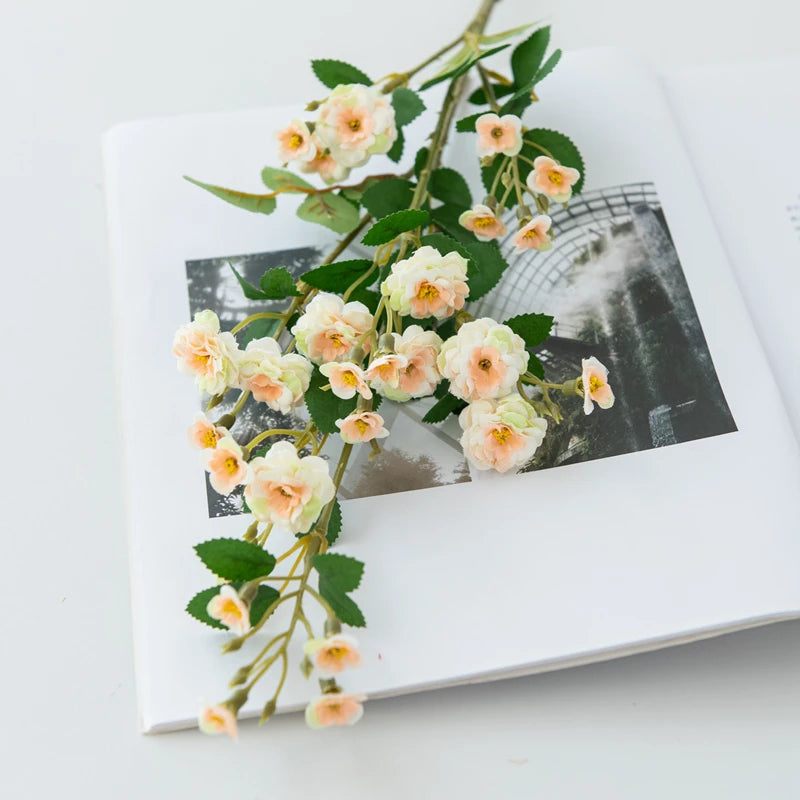 Floral branch on an open book with a blurred background