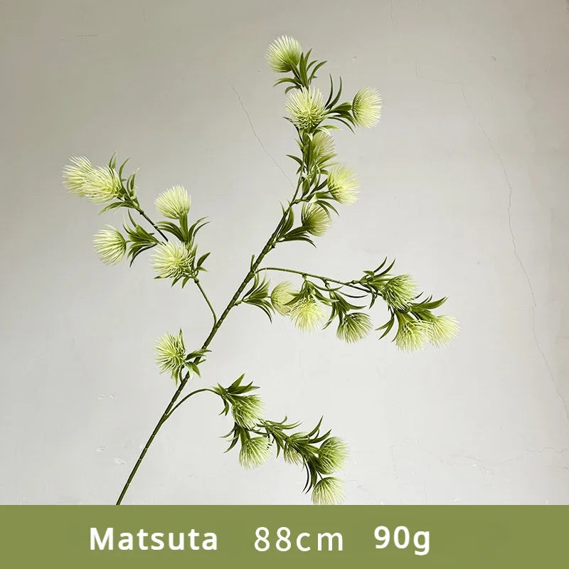 Artificial flower branch with green leaves and buds on a light gray background, labeled 'Matsuta 88cm 90g'.