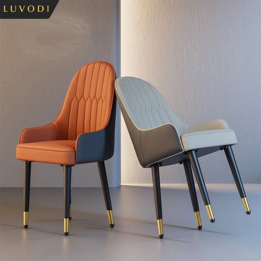 Two modern chairs, one orange and one gray, with gold accents on black legs, against a neutral background.