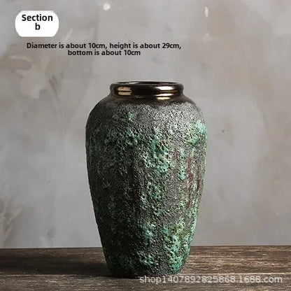 Green textured vase on a wooden surface with a gray background