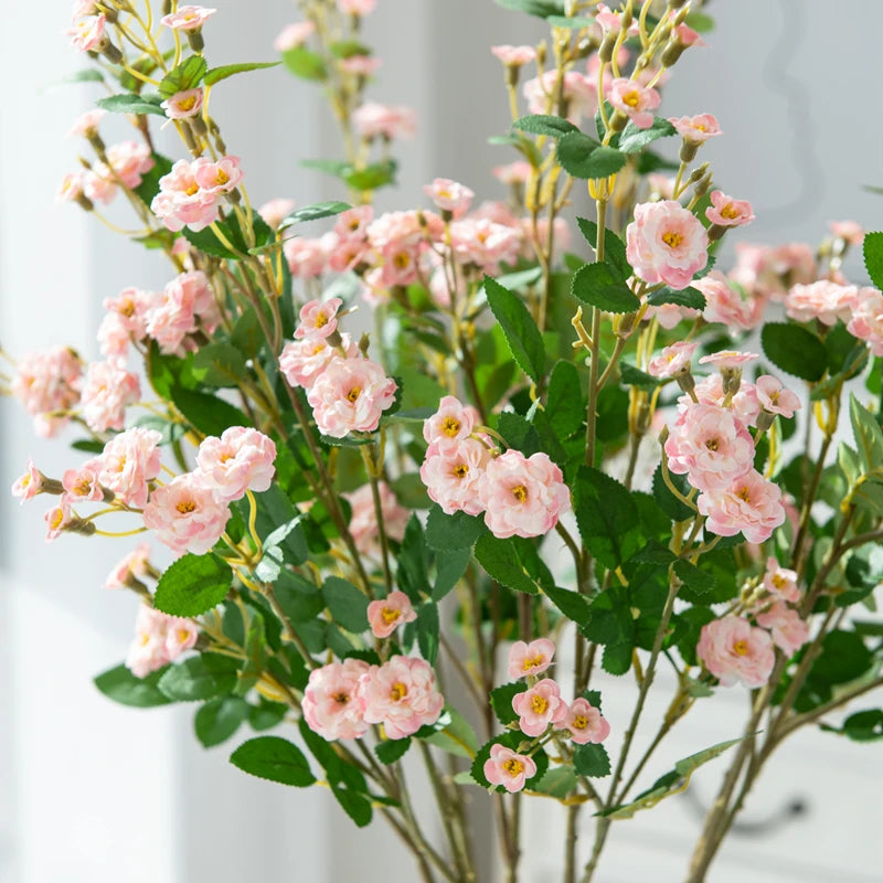 Bouquet of pink flowers with green leaves on a light background